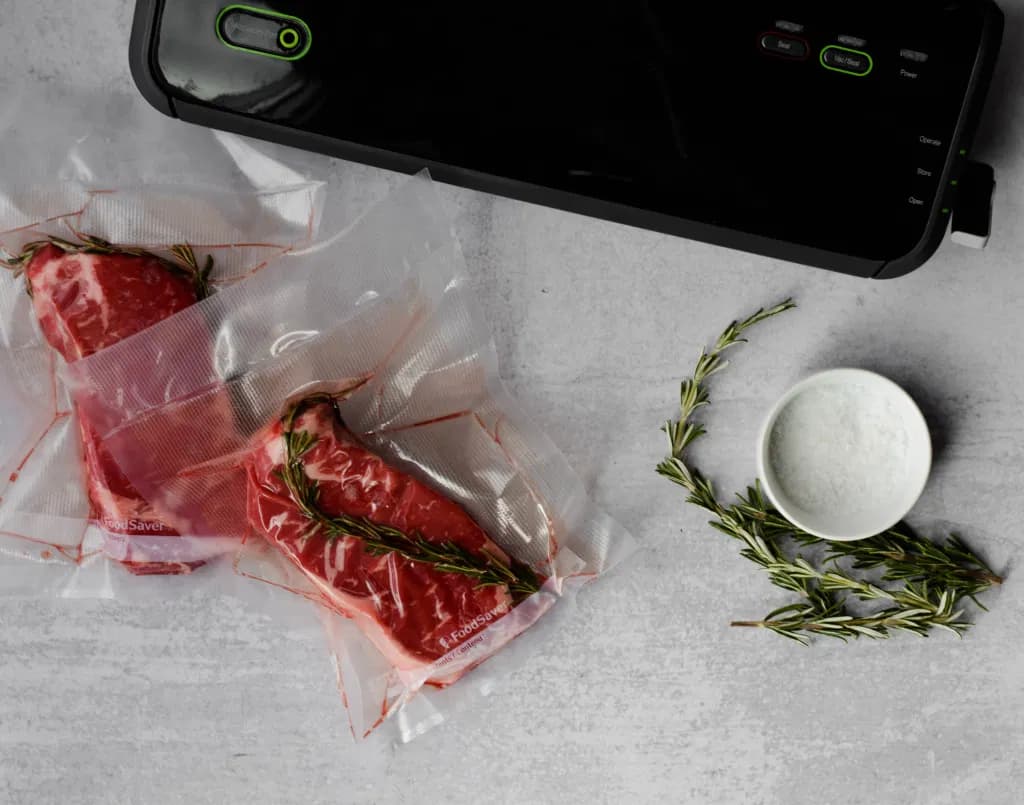 Vacuum sealed steaks with herbs